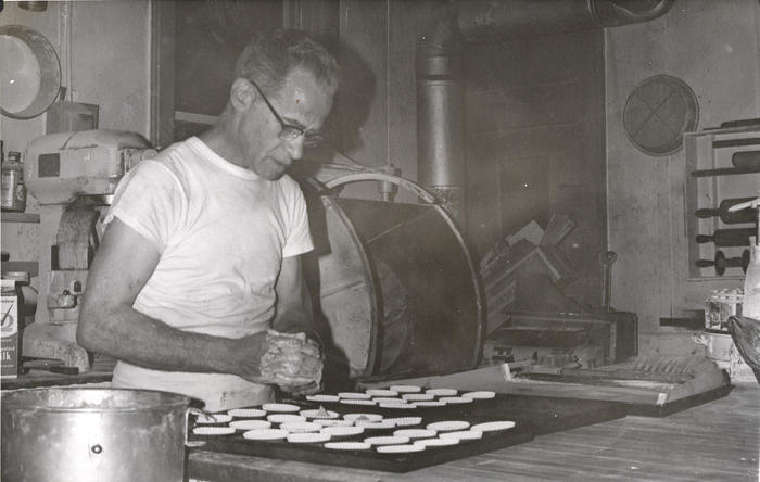 Man filling cupcake pan